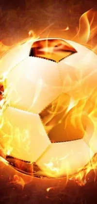 This phone wallpaper displays a close-up view of a soccer ball on fire, surrounded by tumultuous flames