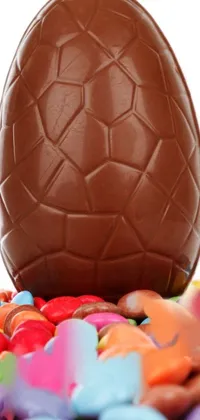 Get this fun and playful live wallpaper for your phone featuring a chocolate egg and a pile of candy