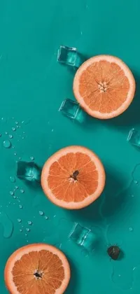 This phone live wallpaper showcases a group of juicy orange slices resting on top of ice cubes, depicted through a photorealistic painting