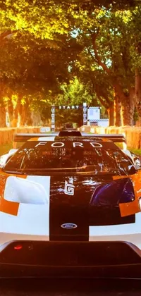 This live phone wallpaper features a white and orange sports car with the "Speed Demon" banner on the side of the road