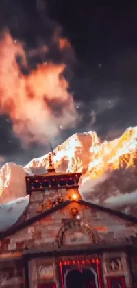 This phone live wallpaper showcases a beautiful church situated at the foot of a grand mountain