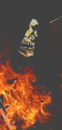 Introducing a phone live wallpaper featuring a fiery scene with a skeleton and a guitar in front of a blazing fire