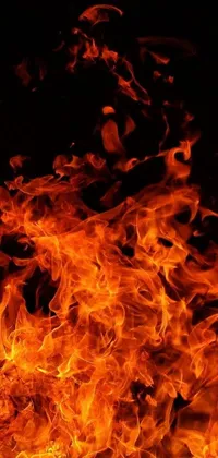 This live phone wallpaper features a close-up view of a blazing fire set against a black background