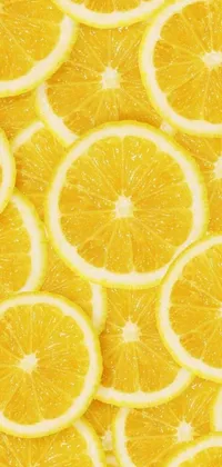 This live wallpaper features a pile of sliced oranges arranged on a bright yellow background