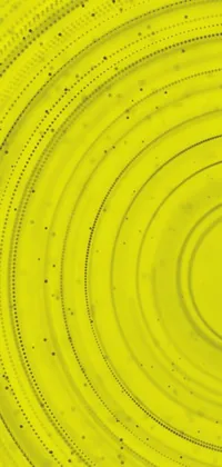 This phone live wallpaper features a bright yellow frisbee sitting on a wooden table, a microscopic photo showcasing intricate patterns, colorful digital art, an abstract formation of dots, a close-up product photo of detail and texture, and mystical spiral lines