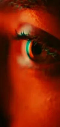Get captivated by this stunning phone live wallpaper! Featuring a close-up shot of an eye in digital art, this wallpaper illuminates an orange and teal lighting style sure to impress cinephiles