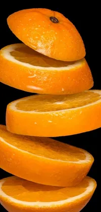 This phone live wallpaper features a visually stunning stack of sliced oranges arranged in a vertical orientation