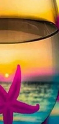 This stunning phone live wallpaper features a mesmerizing vaporwave sunset as the background and a glass of water with a starfish inside as the foreground subject