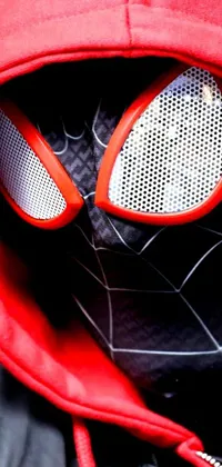 This phone live wallpaper depicts a close-up of the iconic Spider-Man mask