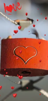 Add a touch of romance to your mobile device with this exquisite live wallpaper! Featuring a close-up photo of a red padlock with a heart drawn on it, this wallpaper represents love and commitment and is perfect for expressing your devotion to your partner