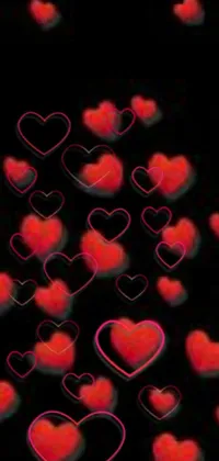 This live phone wallpaper features a collection of red hearts set against a black background, creating a dreamy and romantic effect