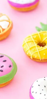 This lively phone live wallpaper features a collection of brightly colored doughnuts on a vibrant pink background