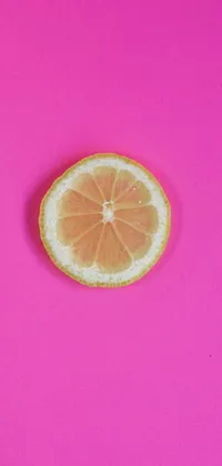 This delightful phone live wallpaper showcases a vibrant grapefruit slice on a dazzling pink background