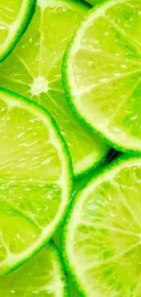 This dynamic close-up phone live wallpaper showcases a stack of halved limes oozing with juice