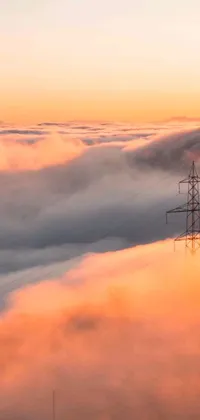 This stunning phone live wallpaper features a towering structure protruding from a sea of clouds in warm and calming hues