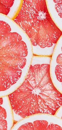 This lively and colorful live phone wallpaper features a digital rendering of a pile of sliced grapefruits