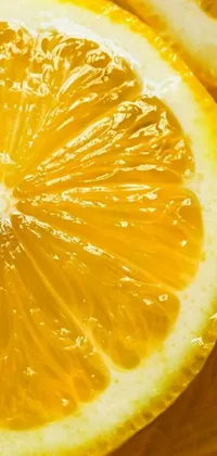 Enhance your phone screen with this stunning live wallpaper featuring a close-up shot of an orange sliced in half