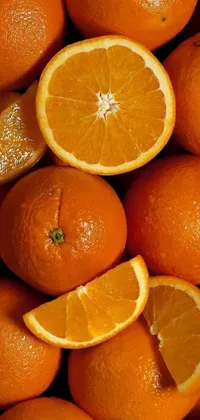 This Phone Live Wallpaper features a detailed close-up photograph of a stack of oranges