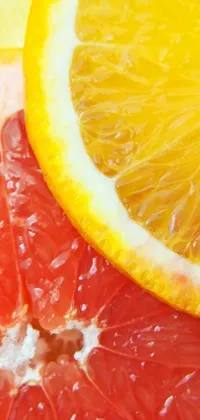 This dynamic phone live wallpaper features a vibrant close-up of a juicy orange slice and grapefruit, captured in exquisite detail by a skilled photographer from istockphoto