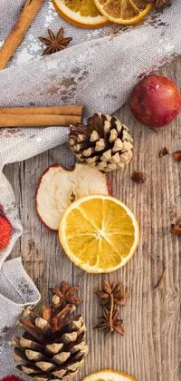 Decorate your phone with a charming live wallpaper of ripe apples, oranges, cinnamon sticks, and star anise nestled on a wooden table