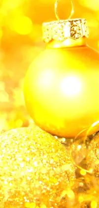 This captivating live wallpaper features a vibrant yellow Christmas ornament set against a stunning gold background