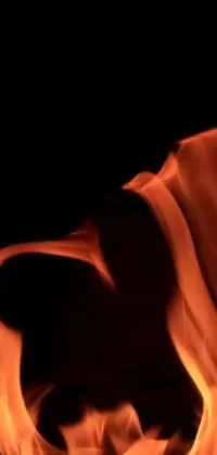 Get this stunning phone live wallpaper that showcases a close up view of a fiery blaze igniting on a black backdrop