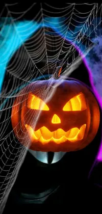 This Halloween phone live wallpaper features a spooky pumpkin sitting on a spider web that emanates creepy black light vibes