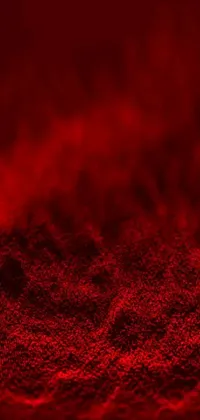 Looking for a mesmerizing phone live wallpaper? This digital art piece by Anna Füssli showcases a striking close-up of a red substance set against a black background