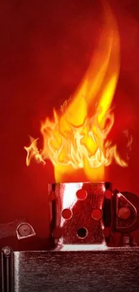 This surreal phone live wallpaper features a close-up of a lighter with a blazing flame