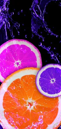 This live wallpaper showcases two oranges floating in blue water on a dark background with accents of purple and orange