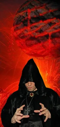 Looking for a phone live wallpaper that is both mystical and ominous? This wallpaper features a man in a black robe, holding a staff with a glowing red orb, standing in front of a fiery red ball resembling a blood moon or a fiery sun