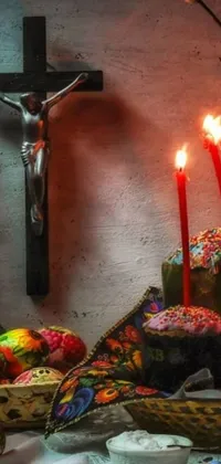 This stunning phone live wallpaper features a wooden table with cakes and candles, set against a mesmerizing Mexican muralism background