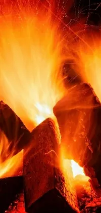 Enhance your phone screen with this captivating live wallpaper featuring an up-close view of a vigorously blazing fire