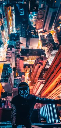 This cyberpunk wallpaper features a person standing fearlessly on a city ledge at night with the glowing cityscape backdrop
