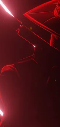 This live wallpaper for your phone showcases a dramatic close-up shot of a red light in the dark