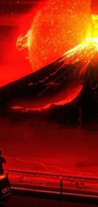 This dynamic phone wallpaper depicts a man standing near his car beside an erupting volcano