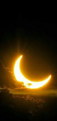 This unique live wallpaper captures the beauty of a partial solar eclipse, displaying a mesmerizing depiction of a crescent moon partially covering the sun as viewed from the sky