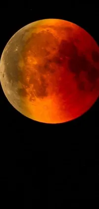 This dynamic live wallpaper features a mesmerizing blood moon shining golden light over a dark background