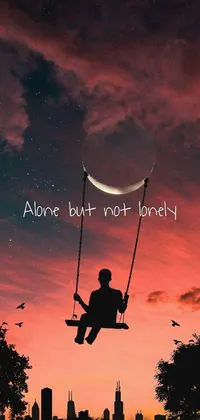 This phone live wallpaper showcases a solitary figure on a swing with the message "alone but not lonely"
