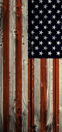 This phone live wallpaper depicts an American flag painted on a wooden wall alongside a patriotic portrait evoking American culture