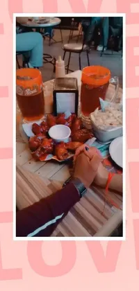 This phone live wallpaper features a stunning scene of food and drinks on a table, designed to add warmth and coziness to your iPhone home screen