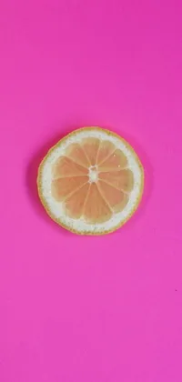 This phone live wallpaper showcases a slice of lemon resting on a soft pink surface - the perfect blend of simplicity and elegance
