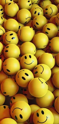 Brighten up your phone screen with this live wallpaper of a pile of yellow smiley faces stacked on top of each other