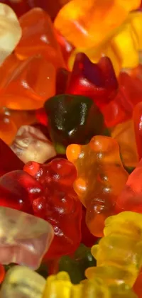 Enhance the aesthetics of your phone with this stunning live wallpaper featuring a fun-filled image of vibrant gummy bears arranged on top of each other
