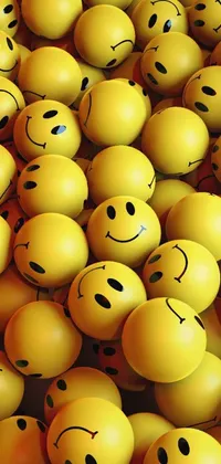 This live wallpaper features a vivid and vibrant pile of yellow smiley faces stacked on top of each other