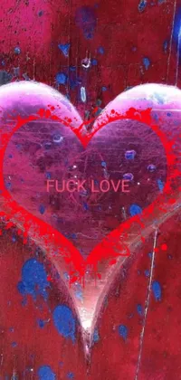 This phone live wallpaper is an eye-catching painting of a red heart with the phrase "fuck love" in graffiti-style lettering
