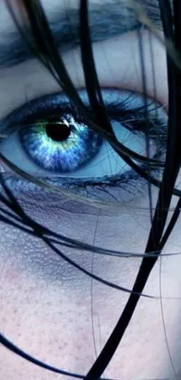 This phone live wallpaper showcases a blue eye up close, capturing every intricate detail including the iris, pupil, and stunning blue glass dreadlocks
