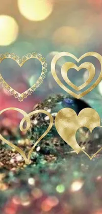 This stunning live wallpaper for your phone features two golden hearts on a table surrounded by intricate bohemian-inspired digital art