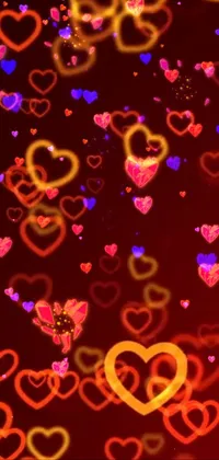 This live wallpaper features multi-colored hearts pulsating in and out of focus on a red background, creating a mesmerizing effect with a neon glow soft bokeh