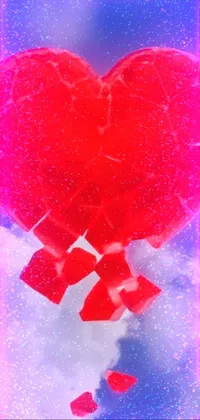 This phone live wallpaper features a red heart atop a snowy ground, surrounded by sparkling glass spheres and a glowing sphere